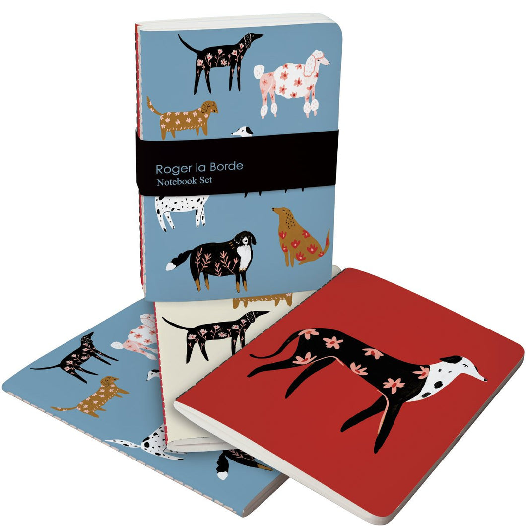 set of 3 roger la borde notebooks of dogs with flowers on their bodies blue and red backdrops