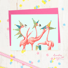 画像をギャラリービューアに読み込む, a grreting card with 3 pink flamingos wearing party hats
