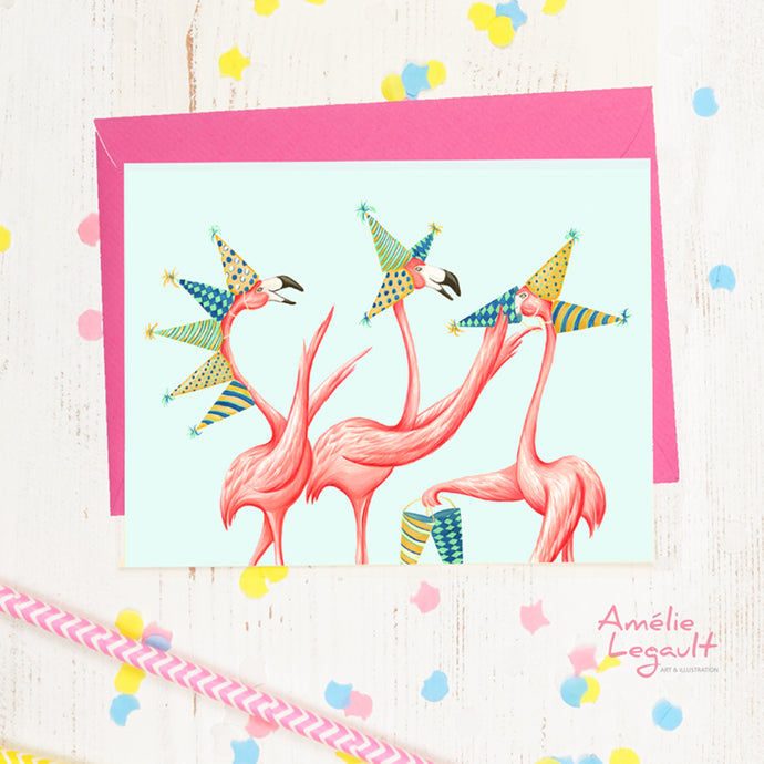 a grreting card with 3 pink flamingos wearing party hats