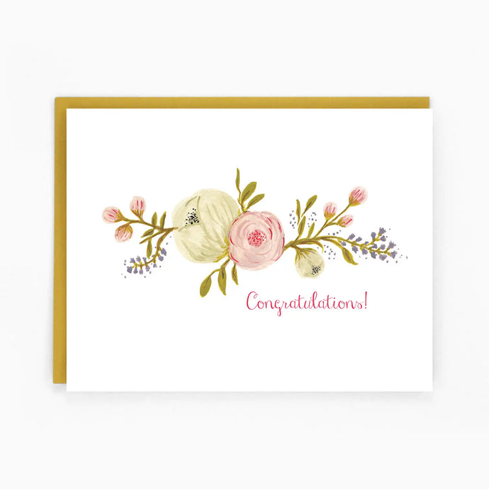 a white greeting card with a beautiful flower spray across the from text congratulations