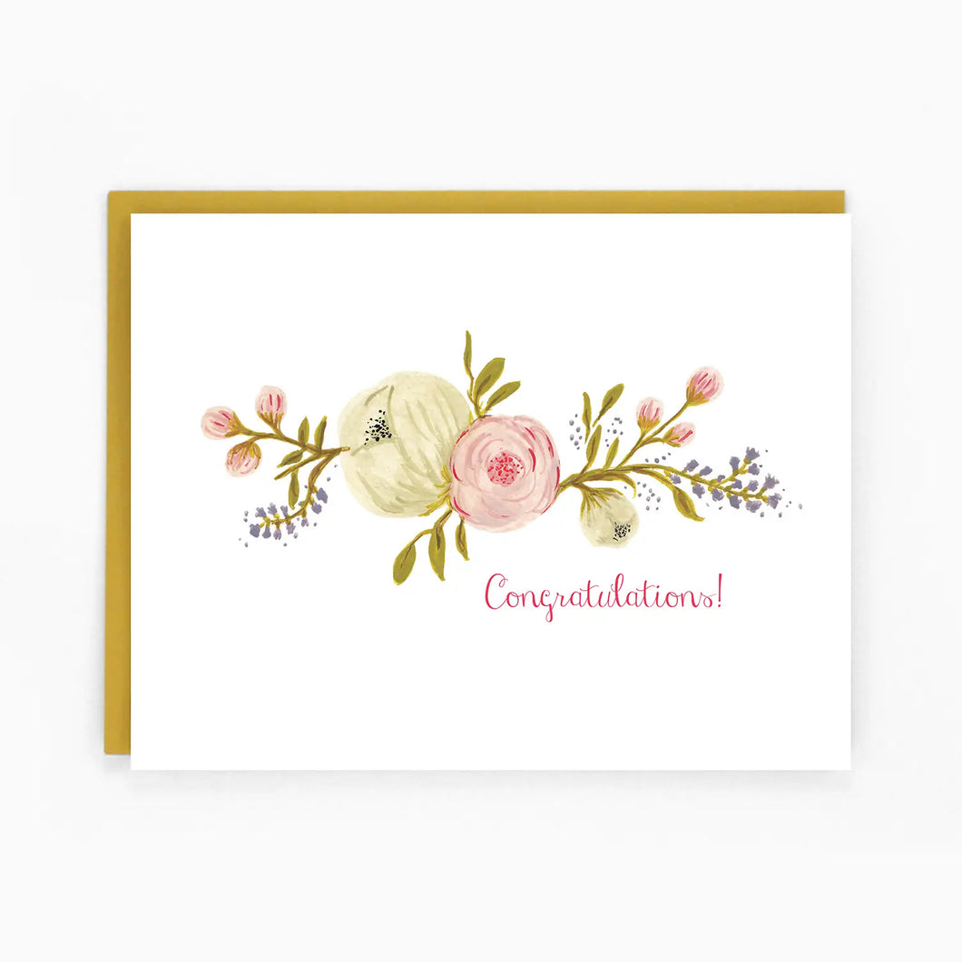 a white greeting card with a beautiful flower spray across the from text congratulations