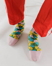 Load image into Gallery viewer,  a colour photo of baggu sock on someones feet with blue yellow and green retro flowers
