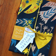 Load image into Gallery viewer, a dark blue tea towel covered in folk art birds of blue and yellow
