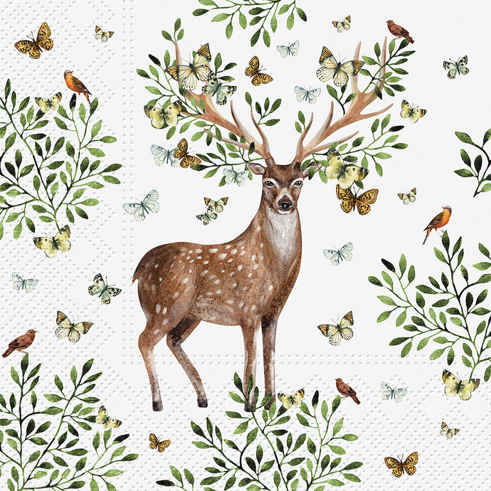 a white paper napkin with a deer surrounded by plants and nature 