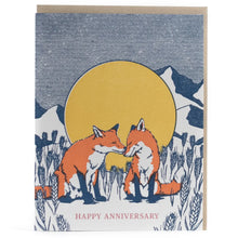 Load image into Gallery viewer, colour illustation of a greeting card with two red foxes nuzzling in front of a large moon and mountain scape with text happy anniversary 
