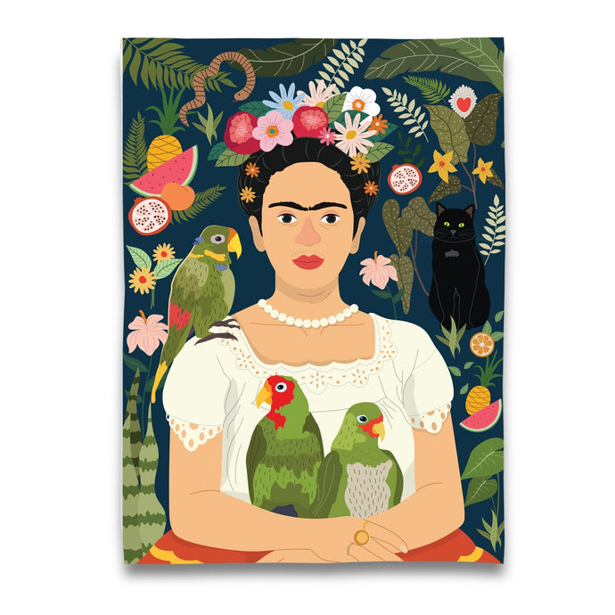 a tea towel depicting artist Frida Kahlo holding 2 parrot birds and a black cat amongst flowers and fruit 