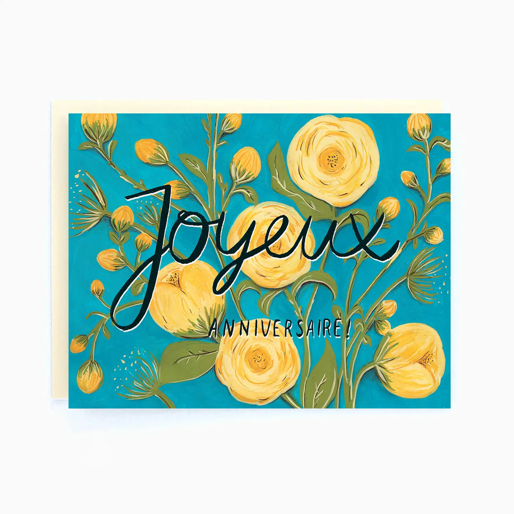 a greeting card with text joyeux anniversaire on a teal background with yellow peonies 