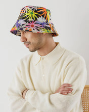Load image into Gallery viewer, a person wearing a baggu bucket hat that is very vibrant and colourful  featuring large flowers and horses 
