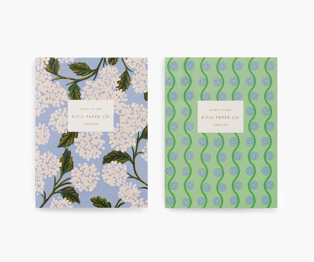 a pair of rifle paper co. notebooks, on white hydrangea the second blue and green swirls 