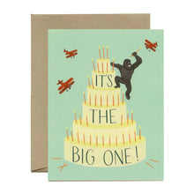 Load image into Gallery viewer, a greeting card with illustration of a giant cake wit king kong on the top reaching out for airplanes as in the movie king kong
