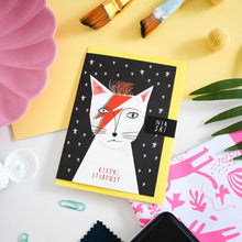画像をギャラリービューアに読み込む, a greeting card featuring a cat that looks like david bowie character ziggy stardust with red makeup on. text. kitty stardust 
