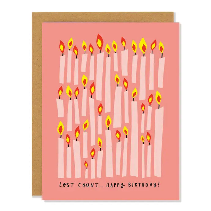 a pink peach coloured greeting card covered in lit birthday candles  text lost count...happy birthday 