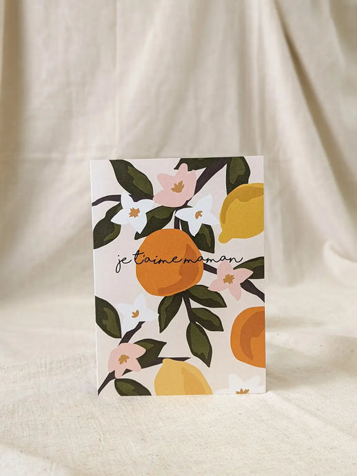 a greeting card with orange fruit and orange blossoms on it text je t'aime maman