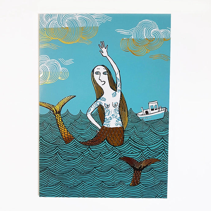 a greeting card with an artist depiction of a mermaid in the sea 