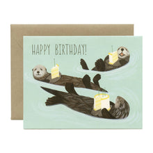 Load image into Gallery viewer, colour illustration of three otters floating on their backs carrying a piece of birthday cake. text happy birthday 
