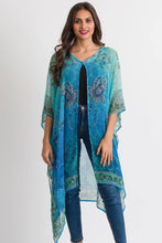 Load image into Gallery viewer, woman wearing a turquoise coloured  flowing caftan 
