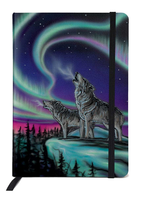 color phot of a journal depicting two wolves howling at the moon amidst the northern lights 