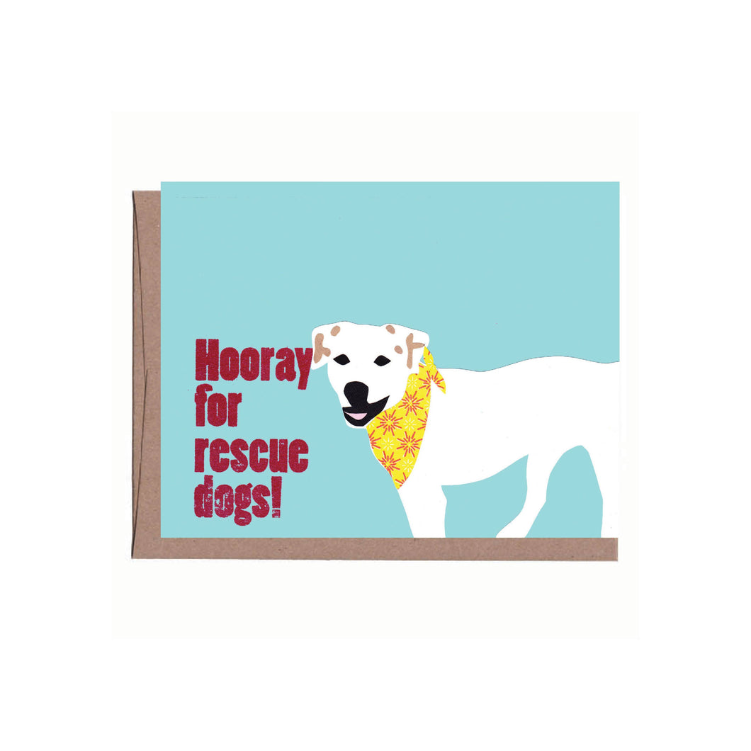an illustration of a white dog wearing a yellow bandana on a soft blue background says hooray for rescue dogs 