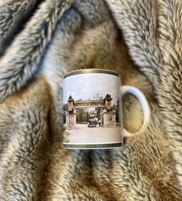 a coffee mug with a colour vintage photo of the riding mountain national park manitoba  canada east gate entrance 