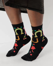 Load image into Gallery viewer, a person wearing black baggu rodeo socks with horseshoes and cherries s on them 
