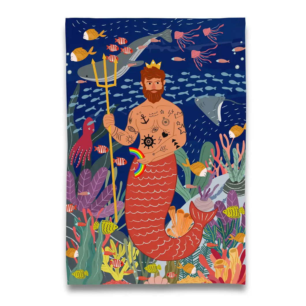 a tea towel with a colour painting of a merman holding a small rainbow under the sea with all sorts of fishes and coral 