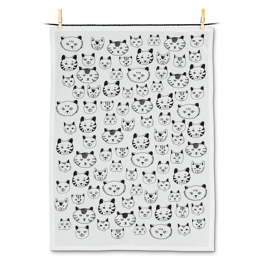 black ink illustration of all sorts of cat faces on white tea towel