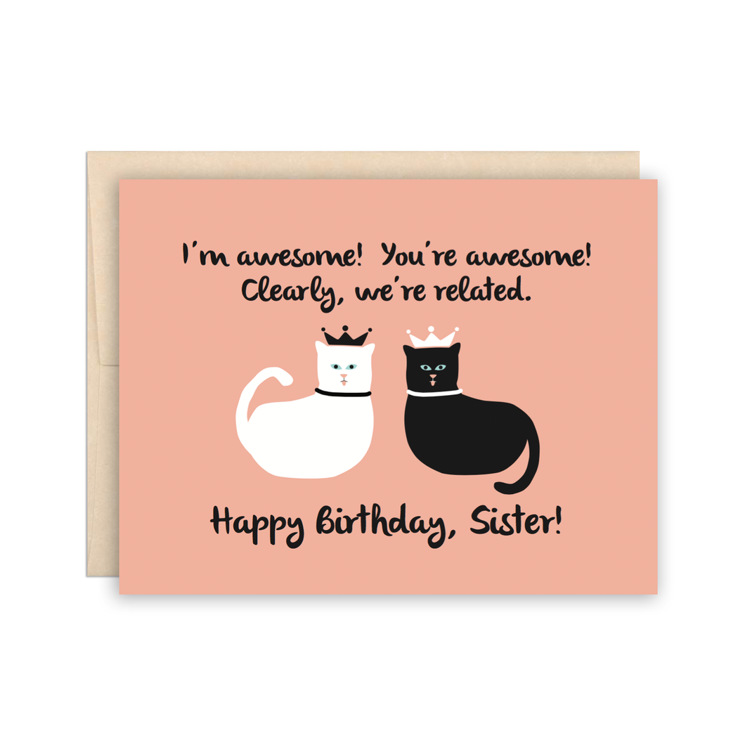 a soft pink card with an illustration of a black and a white cat both wearing little crowns like royalty