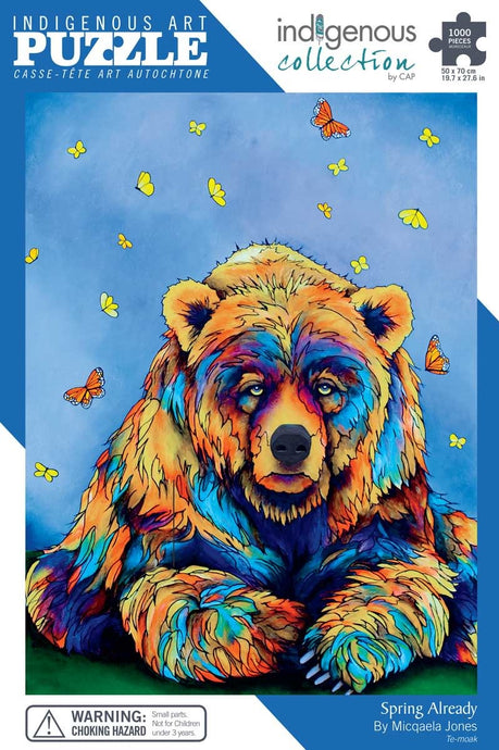 colourful Indigenous illustration of a big bears face and paws with little butterflies above on mostly blue back drop