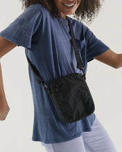 Load image into Gallery viewer, a person wearing a baggu brand crossbody purse in a black colour with black strap
