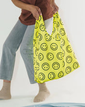 Load image into Gallery viewer, the baggu reusable bag with a yellow happy face pattern
