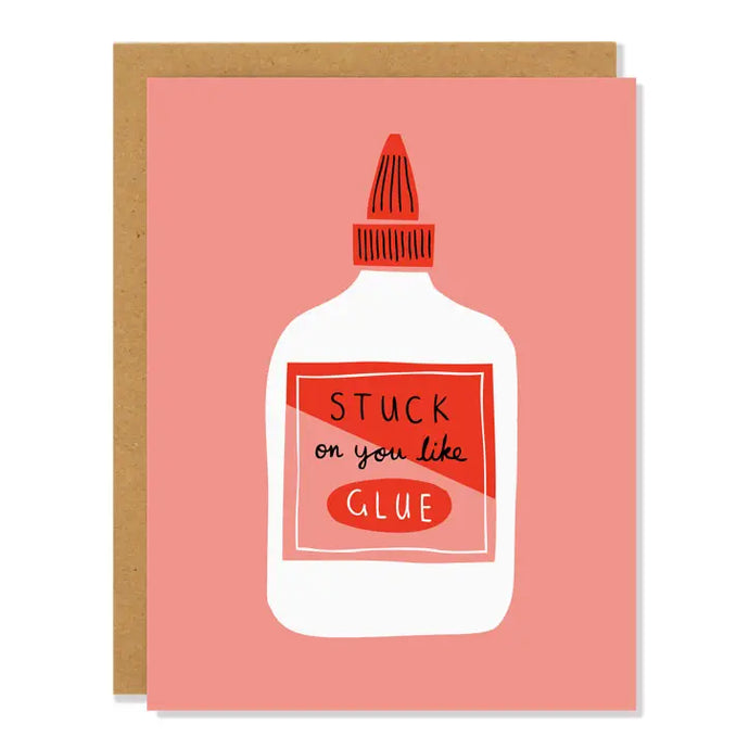 pink coloured greeting card with an illustration of a bottle of glue or paste with text on bottle stuck on you like glue 