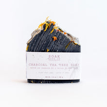 Load image into Gallery viewer, a bar of soak bath co. charcoal tea tree soap
