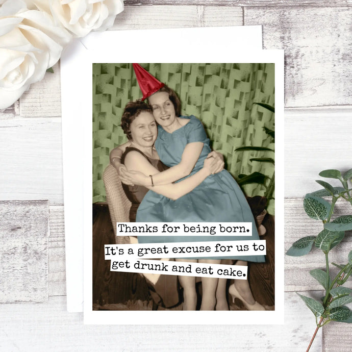 colour photo of two mid 1960's women hugging with party hats on. text thanks for being born. it's a great excuse to get drunk and eat cake 