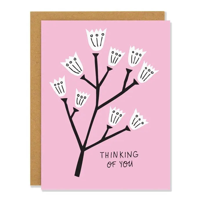 a pink coloured greeting card with black stemed white flowers. text thinking of you. modern illustratio