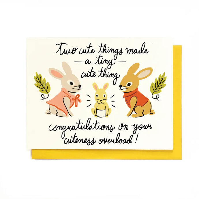 a greeting card with two large bunnies gazing at a baby bunny with text two cute things made a tiny cute thing congratulations on your cuteness overboard