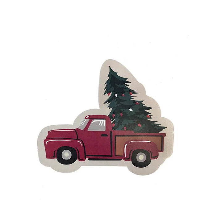 a holiday Christmas napkin in the shape of a pickup truck that is red and has a green evergreen tree in the back 