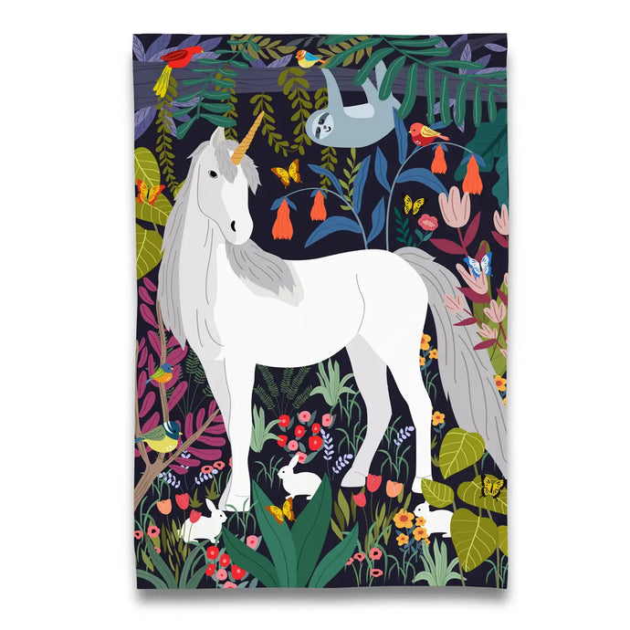 a tea towel depicting a large white unicorn in a tropical forest 