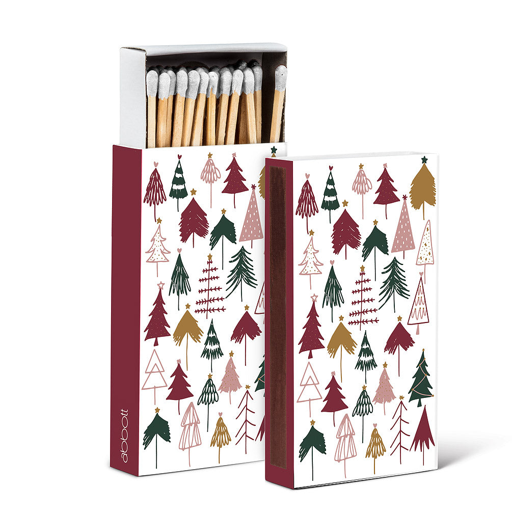 a colour phot of two boxes of matches. depicting assorted holiday trees as a motif 